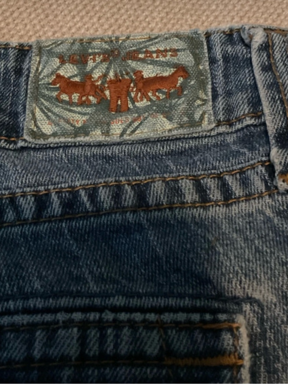 Vintage Low Y2K Levi's 542 Capri Medium Blue Denim Jeans with Brown Patch